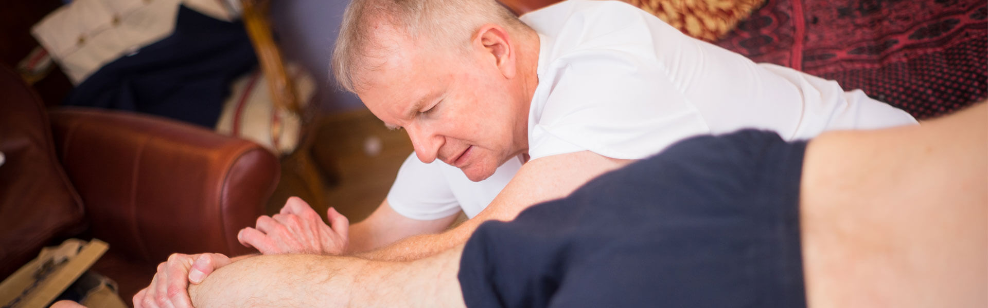 Slider image showing curative massage to leg